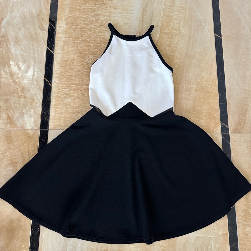 Girls black and white dress size 12 with sheer inserts on the sides button close